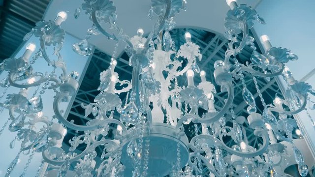 Amazingly beautiful luxury chandeliers with sparkling crystal candelabra sold in the store. Shot in motion