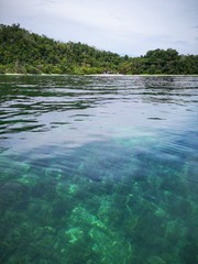 Beautiful crystal clear water with healthy coral reefs undersea from surface of Gaya Island, Tunku Abdul Rahman Park, Kota Kinabalu. Sabah, Malaysia. Borneo.