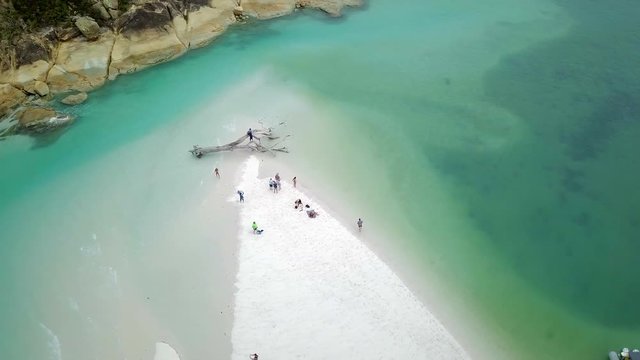 Aerial Spin Right: Crowd In Light Blue Ocean Relaxing On Sandy Island, Whitsunday Islands, Australia