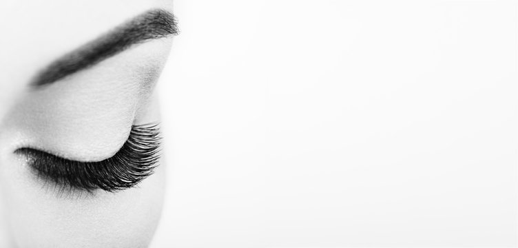 Female Eye with Extreme Long False Eyelashes. Eyelash Extensions. Makeup, Cosmetics, Beauty. Close up, Macro