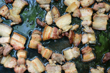 Slices of bacon on a hot cast-iron pan. Cooking in the campaign at the stake.
