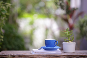 Blue coffee cup pot and notebooks at outdoor