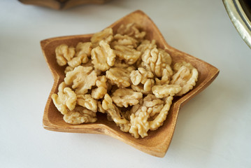 Walnuts kernel in wooden bowl, close-up, healthy snack food. 