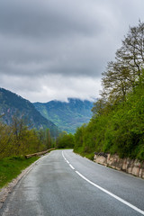 Fototapeta premium Montenegro, Curved twisting road through tara canyon dangerous to drive fast in this beautiful green nature scenery