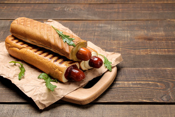 French hot dogs. Tasty hot dogs on the board on a brown wooden table. fast food street food....