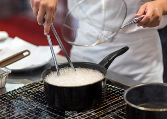 Chef is cooking french fries in the kitchen, Chef cooking fried potato in pan