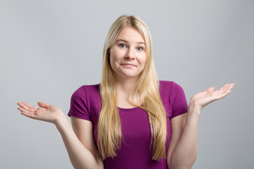 young woman in red shirt shrugs
