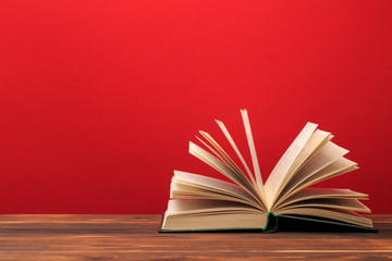 Open book  on red background. text place .