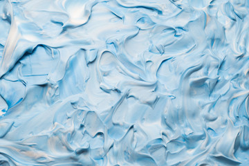 Blue and white acrylic paint art background. Smeared tooth paste abstract design.