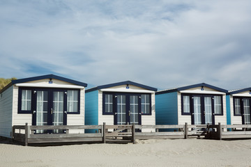 Fototapeta na wymiar Row of White Beach Houses on a Sandy Shore