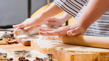 Family leisure and cooking hobby. Cropped shot of mother and daughter rolling dough in flour,...