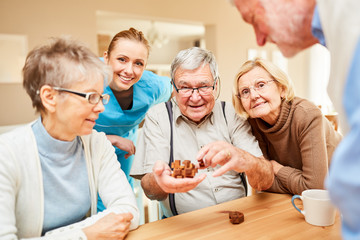 Seniors have fun with a wooden puzzle