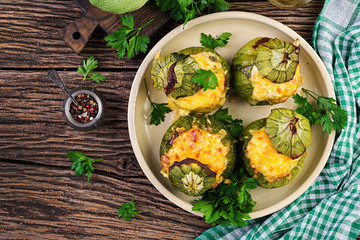 Zucchini stuffed with minced meat, cheese and green herbs. Baked in oven. Top view