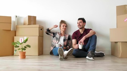Young couple catching a break while moving house  - Powered by Adobe