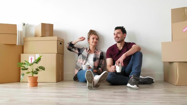 Young couple catching a break while moving house 