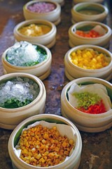 Mise en place of little dishes with ingredients for making tropical ceviche