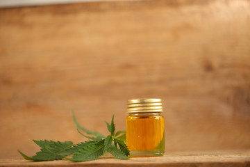 cbd oil bottle and hemp leaf