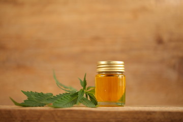 cbd oil bottle and hemp leaf