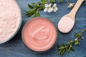 Cosmetic clay. Pink cosmetic clay in different types on a blue wooden table. face mask and body....
