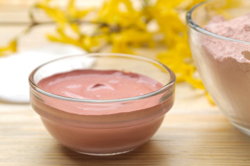 Cosmetic clay. Pink cosmetic clay in different types on a natural wooden table. face mask and body. care products. spa.