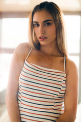 Portrait of young woman in striped summer dress