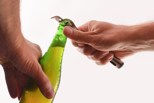 Hands Open A Beer Can With Bottle Opener Isolated White