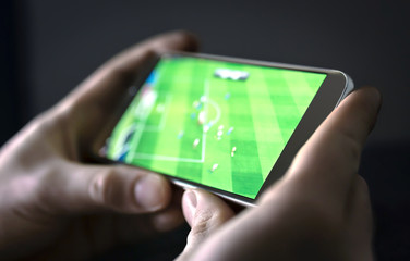 Watching football and sport stream with mobile phone. Man streaming soccer game live, video replay...