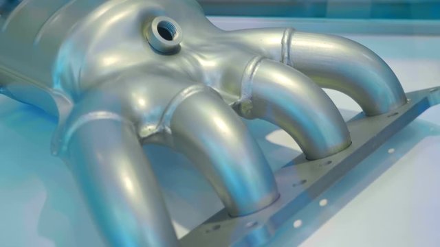 New muffler with exhaust catalytic converter is presented for review at the exhibition. Shot in motion