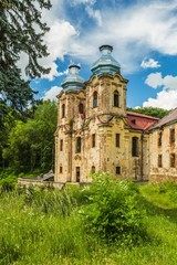Fototapeta na wymiar Skoky, Zlutice / Czech Republic - June 21 2019: Baroque church of the Virgin Mary Visitation in Skoky, Maria Stock, is a former pilgrimage place in West Bohemia. Sunny day, blue sky with clouds.