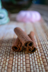 Cinnamon sticks and sweets (Turkish delight, marshmallow, cookies) in close-up on a wooden table.