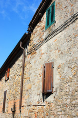 Fototapeta na wymiar Ancient Italian house with windows and shutters
