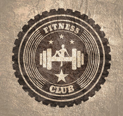 Sporty woman sits on a dumbbell. Short hair girl silhouette. Fitness club text. Emblem for sport club. Stamp in the ornamental frame