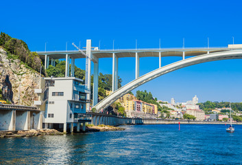 Naklejka premium Arrabida Bridge in Porto Portugal, crossing the Douro River and linking Porto with Vila Nova de Gaia