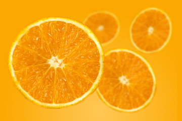Naklejka na ściany i meble background of half cut orange on orange background