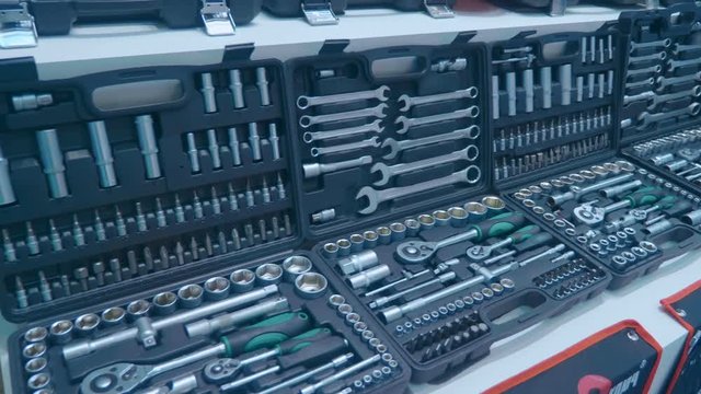 Suitcases with a set of shiny chrome tools for car repairs. Shot in motion