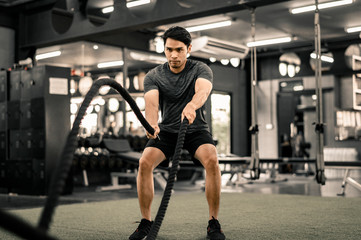 Fototapeta na wymiar Fit young man workout in a gym