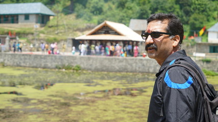 man standing in front of house