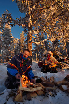 Nils-Torbj&ouml;rn Nutti, owner and operator at Nutti S&aacute;mi Siida, and Klara Enbom-Burreau on snowmobile trip into the wilderness, Jukkasj&auml;rvi, Lapland, Laponia, Norrbotten county, Sweden