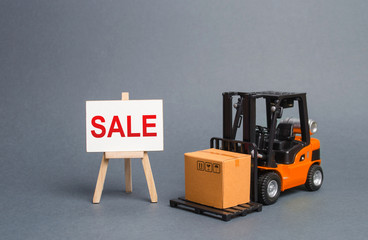 Orange forklift truck carries a cardboard box and a stand with a word sale. growth of sales. big discounts on goods of the outgoing season. commodity exchange with other countries. Attracting buyers