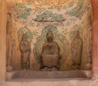 Relief of Buddha and Bodhisattvas with colorful fresco in Grotto 86 in Bingling Temple and Grottoes, Yongjing, Gansu, China. UNESCO World Heritage Site.