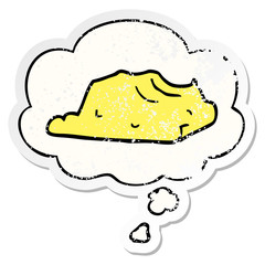 cartoon butter and thought bubble as a distressed worn sticker