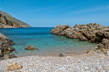 Fototapeta na wymiar The seashore at Cala Beretta in the Oasi dello Zingaro natural reserve, San Vito Lo Capo, Sicily