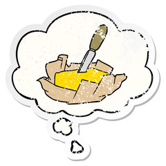 cartoon butter and thought bubble as a distressed worn sticker