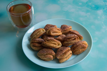 Biscuits with cottage cheese, tea with lemon and raspberry jam