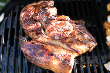 Joint of beef cooking on an outdoor grill