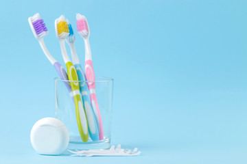 Oral hygiene. Toothbrush, dental floss and toothbrush sticks on a gentle blue background. space for...