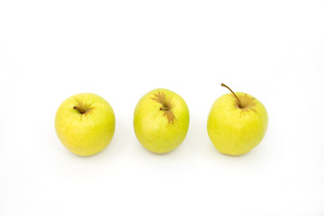Three yellow apples in a row on a white background