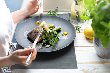 Dinner in a restaurant. Exquisite dish, grilled salmon on green asparagus