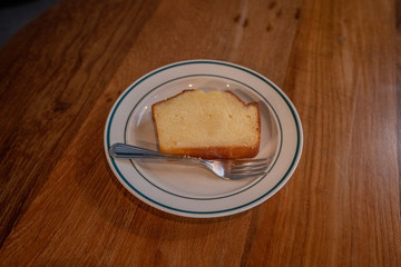 Slices of delicious butter cake or pound cake on white plate put on wood table with copy space for background or wallpaper.