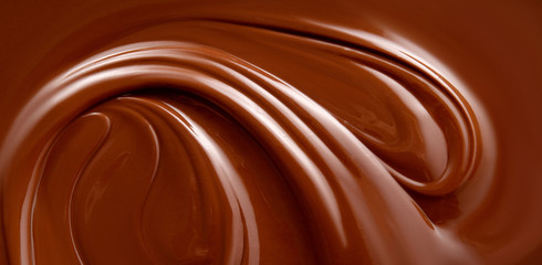 Naklejki  Czekoladowe tło. Stopiona powierzchnia czekolady. Powierzchnia czekolady.